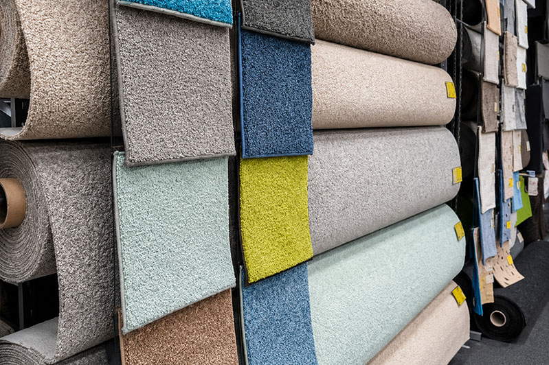 Discounted in-stock flooring rolls and boxes marked with liquidation sale pricing